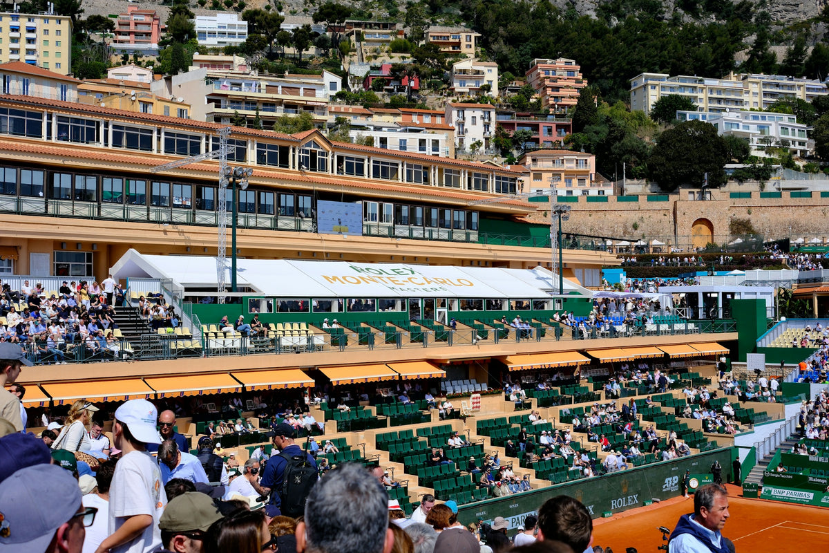 A tennis match underway in a stadium filled with spectators
